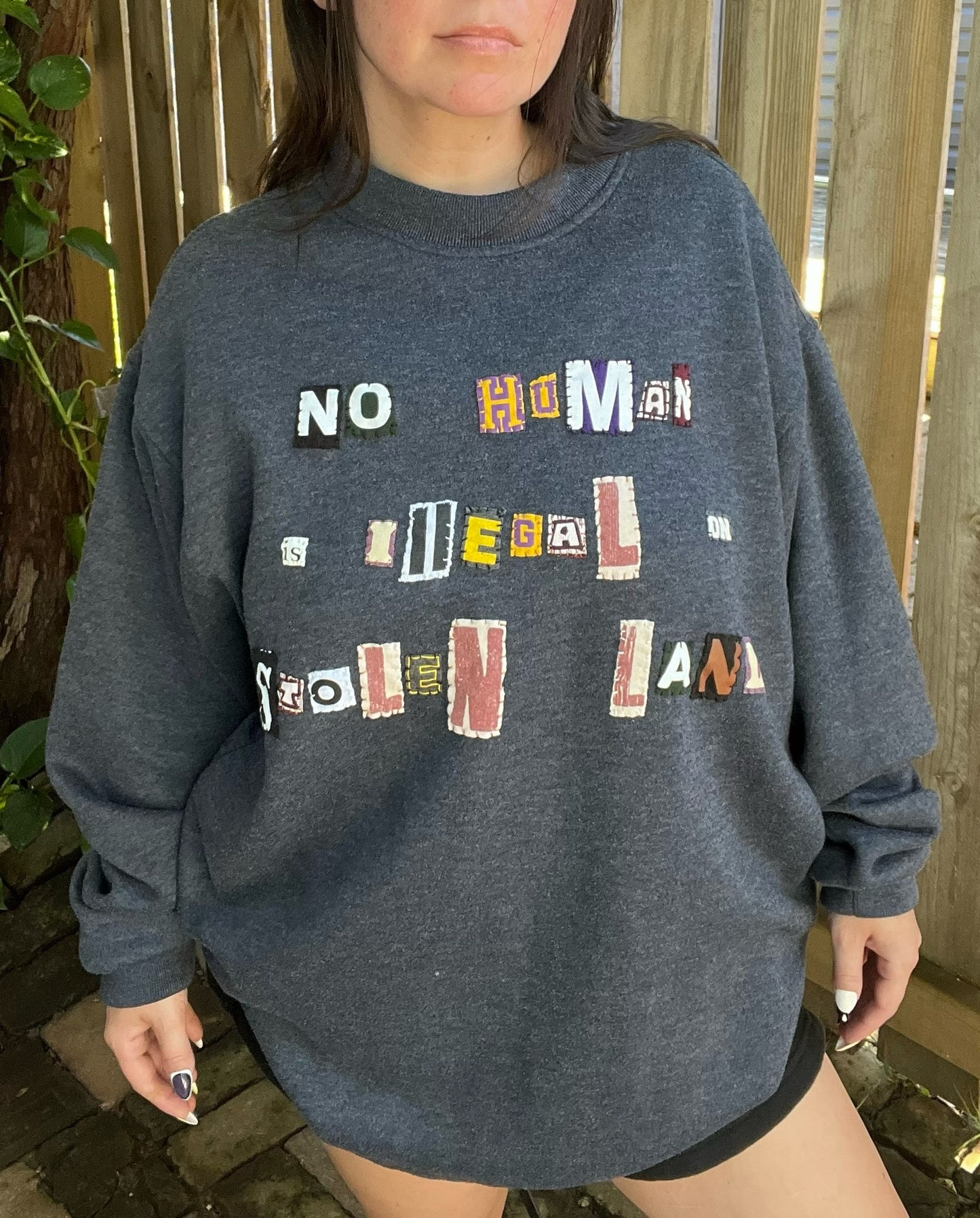 NO HUMAN IS ILLEGAL ON STOLEN LAND Navy Crew | XL