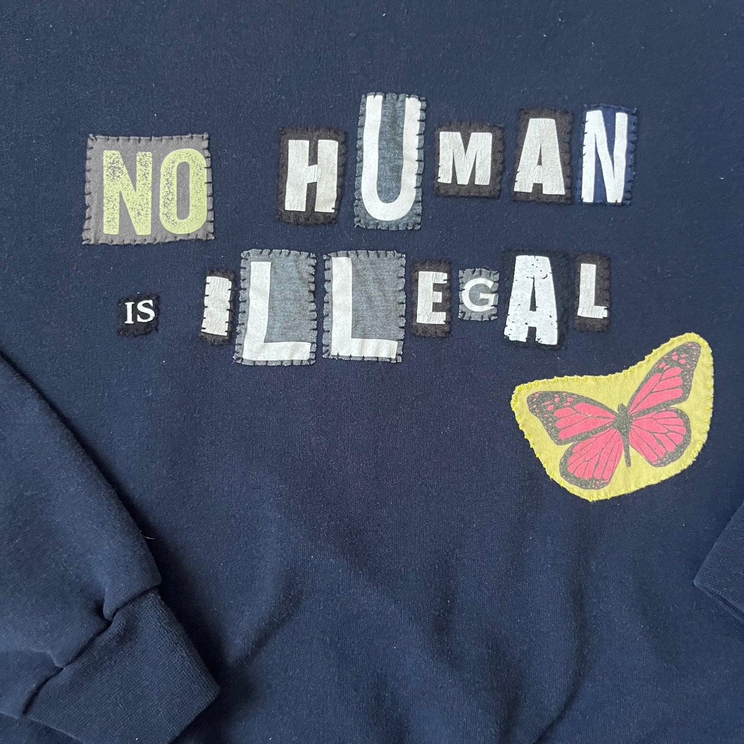 NO HUMAN IS ILLEGAL | M