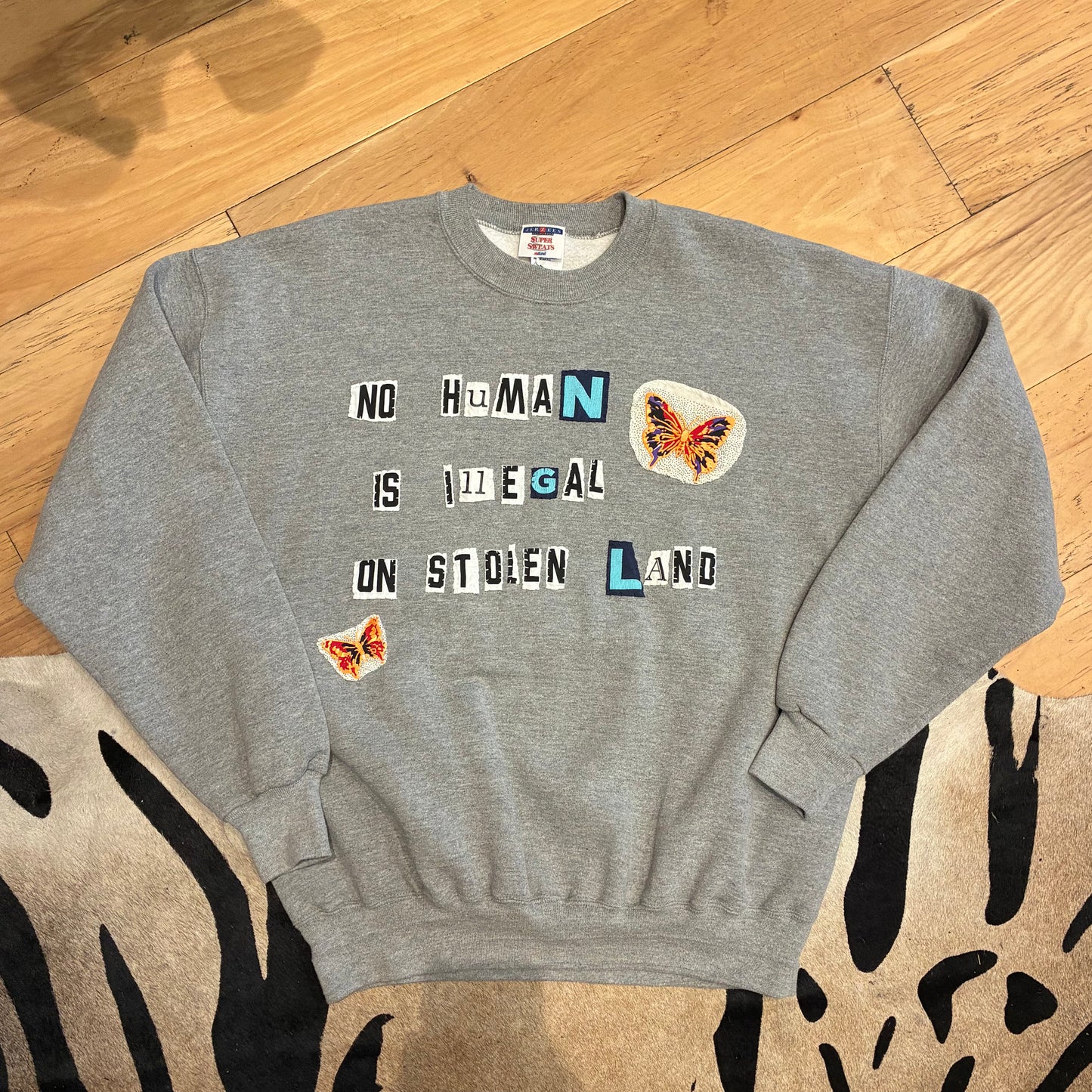 NO HUMAN IS ILLEGAL | XL